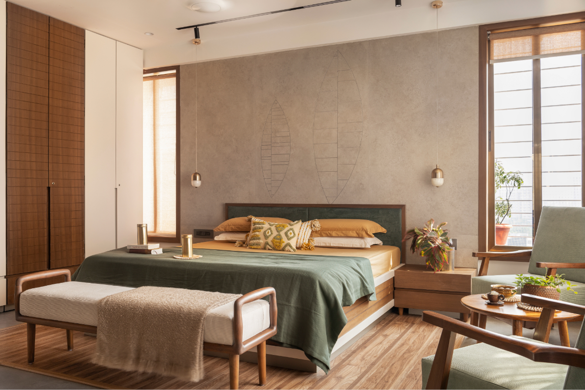 Wide view of the master bedroom — timber platform, brass pendants, wardrobe wall, mint chairs catching afternoon light from the full-height windows
