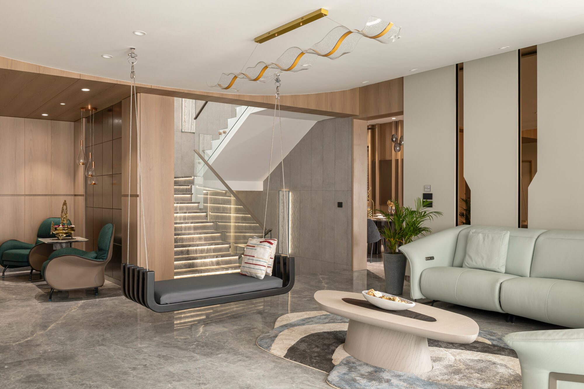 Wide view of the penthouse living room — striped chairs, diagonal LED, grey marble