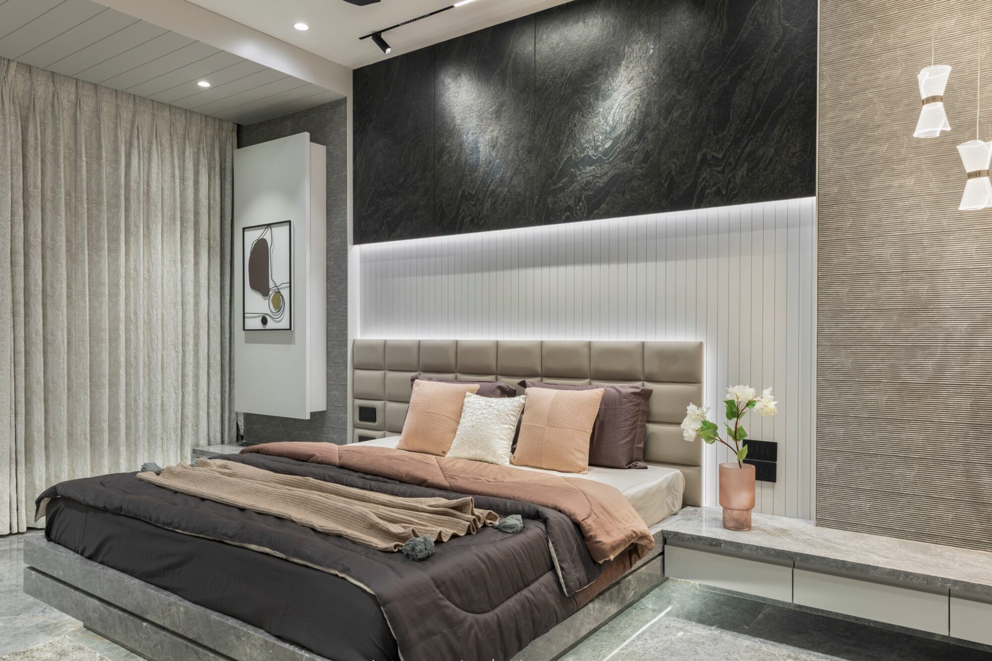 The master bedroom — fluted white headboard with backlit diagonal accent, dark upholstered bed, soft pink-and-tan palette
