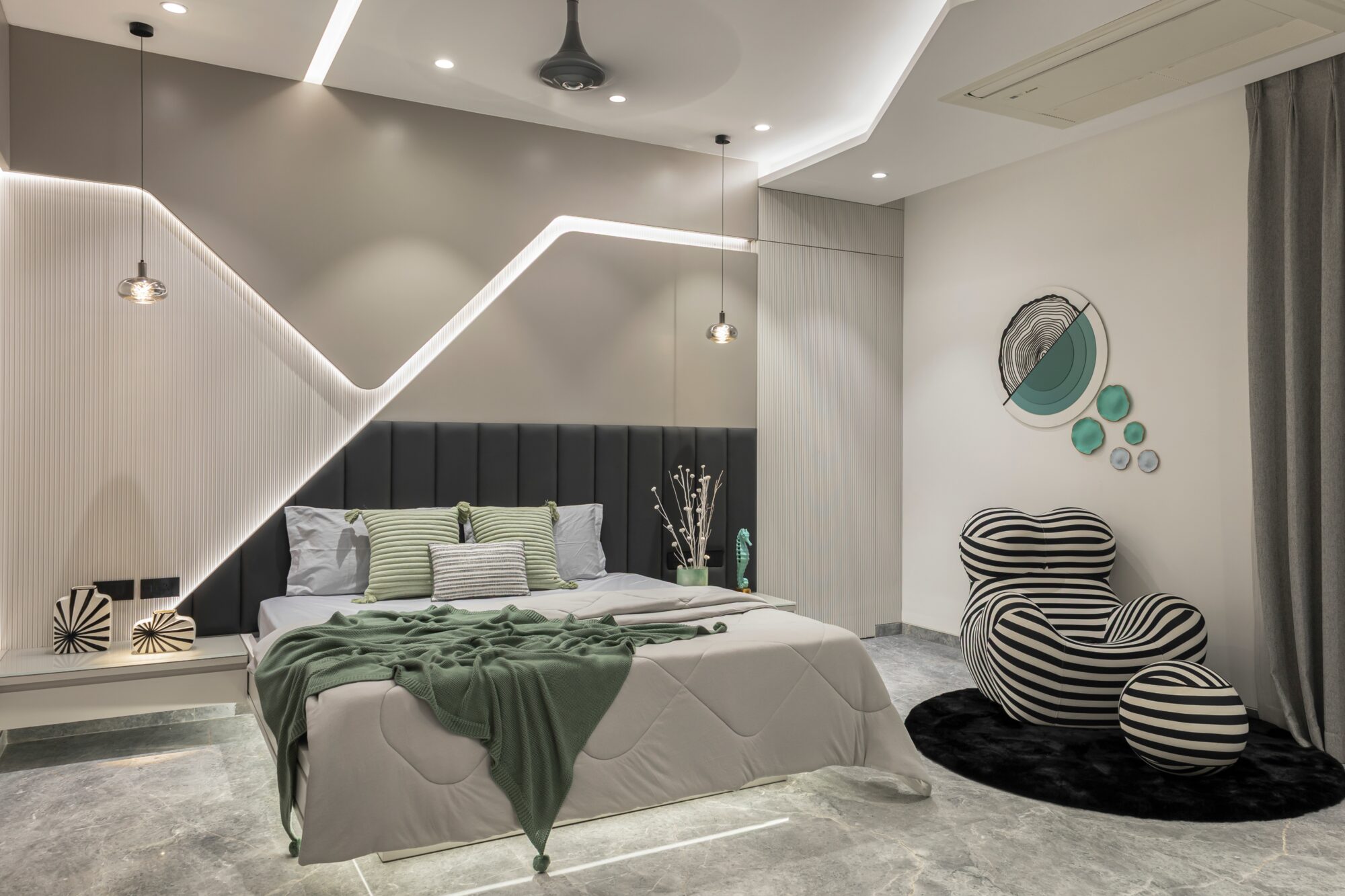 The elder son's bedroom — diagonal LED cutting the wall, dark upholstered headboard, striped statement chair