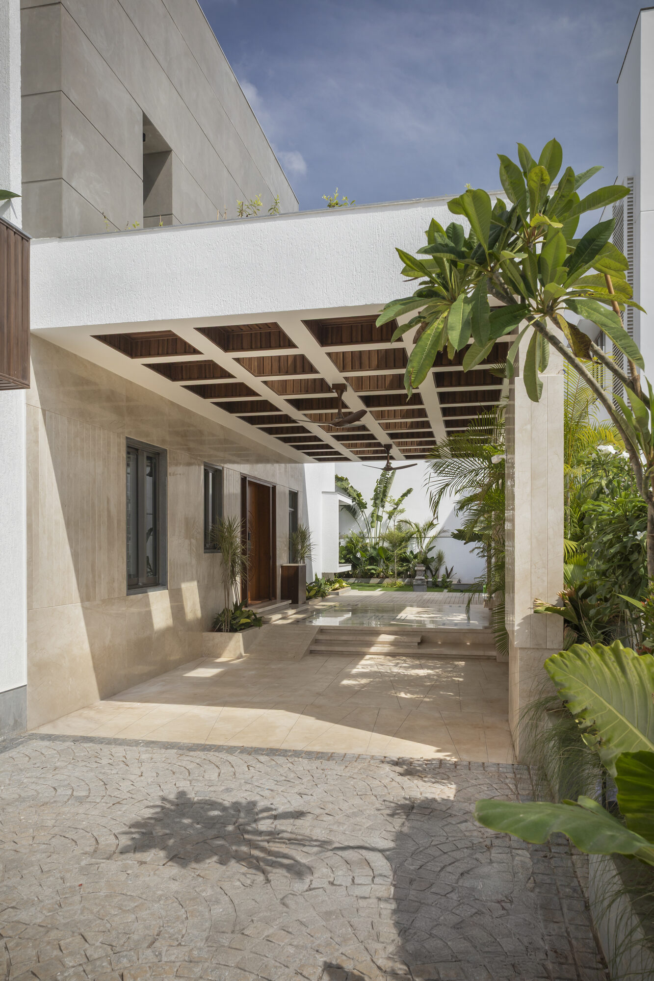 Entrance canopy with coffered timber ceiling and travertine court
